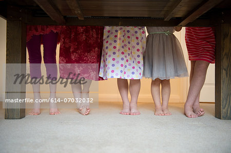 Girls standing together with barefeet in a row, low section