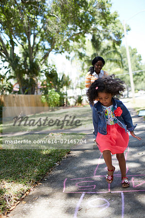 Girl doing hopscotch