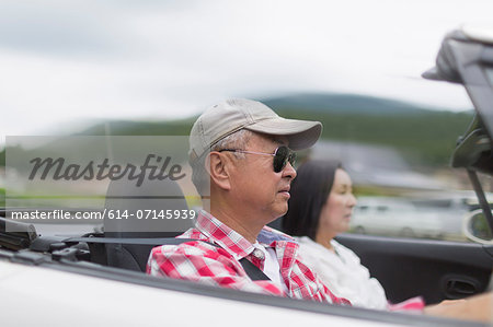Couple enjoying leisurely drive in sports car