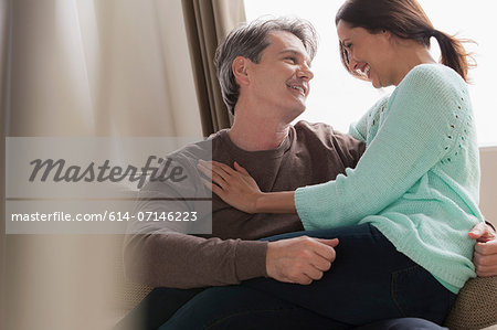 Mature couple hugging on sofa