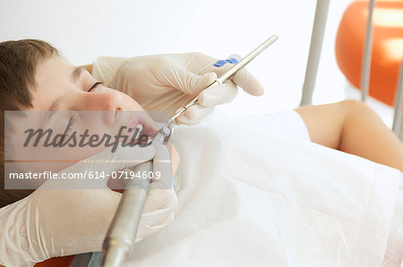 Boy patient receiving dental treatment