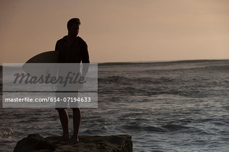 Silhouette of young male surfer, San Diego, California, USA