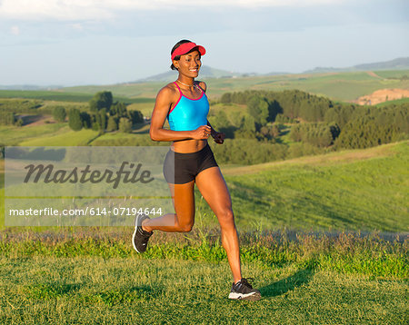Young woman running in landscape, Othello, Washington, USA Young woman running in landscape, Othello, Washington, USA