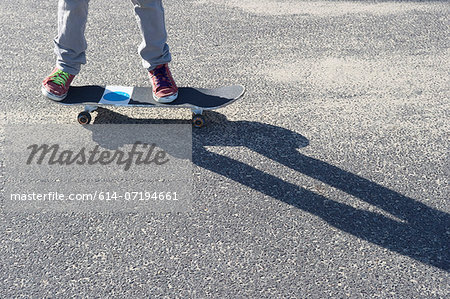 Detail of legs riding skateboard