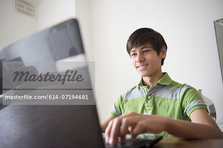 Teenage boy using laptop