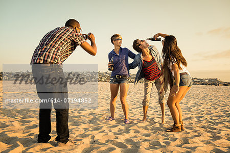 Man photogrpahing friends on Mission Beach, San Diego, California, USA