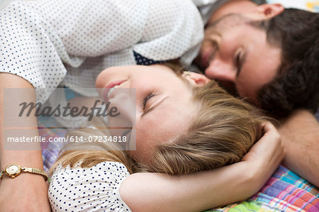 Close up of couple relaxing on bed