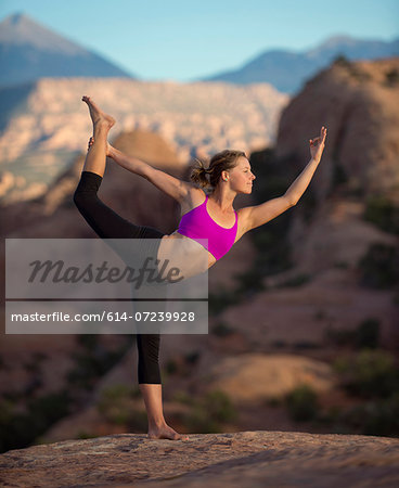 Young woman doing yoga, Moab, Utah, USA