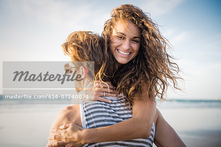 Young couple hugging in San Diego beach Young couple hugging in San Diego beach