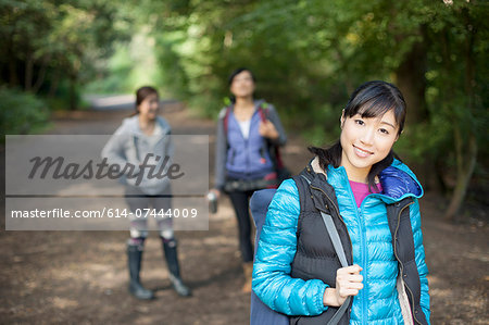 Three young female hikers on country road