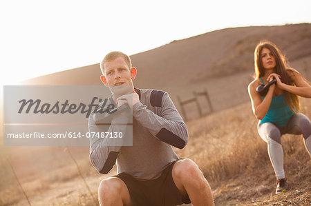 Couple working out with weights Couple working out with weights