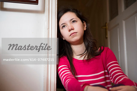 Girl leaning against doorway