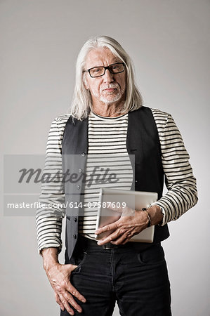 Portrait of mature man, holding digital tablet Portrait of mature man, holding digital tablet