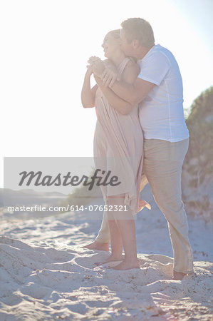 Mature couple hugging on beach