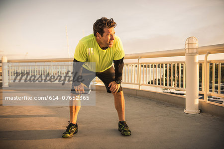 Exhausted male runner taking a break