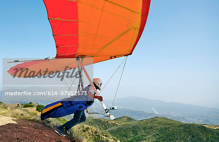 Hang glider pilot taking off