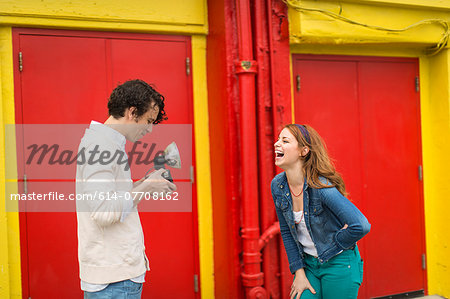 Couple having a laugh whilst taking photograph
