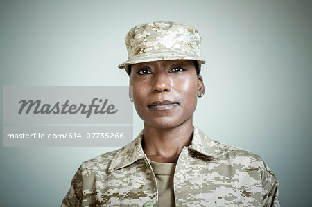 Studio portrait of confident female soldier