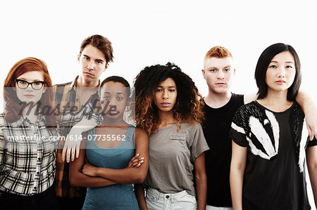 Formal studio portrait of six serious young adults