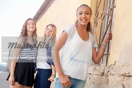 Teenage girl, friends in background