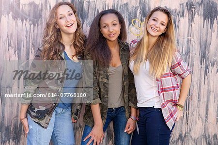 Teenage girls by wall with drip mark pattern