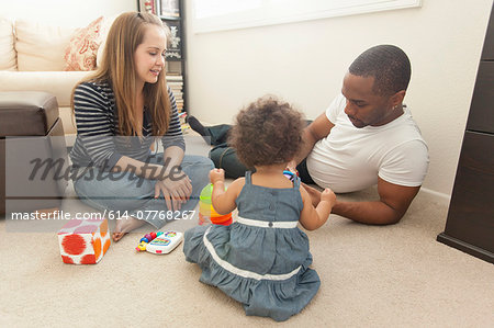 Mother and father playing with young daughter