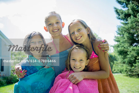 Girls in swimming costume wrapped in towels