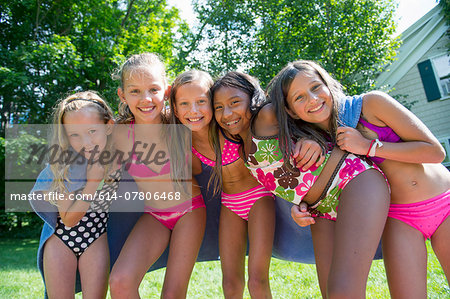 Girls in swimming costume wrapped in towel