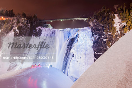 View of snowmobiles in front of frozen Montmorency Falls Park at night, Quebec City, Quebec, Canada