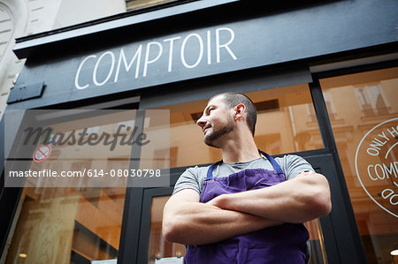 Portrait of restaurant owner, outside his business, low angle view