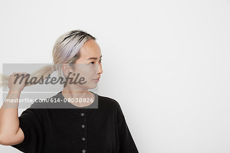 Woman holding her pony tail Woman holding her pony tail