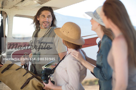 Tour guide with tourists beside plane, Wellington, Western Cape, South Africa