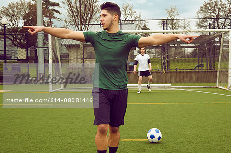 Young male soccer player preparing to take a penalty