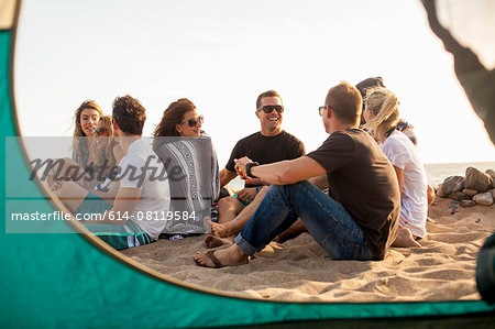 Group of friends camping on beach Group of friends camping on beach