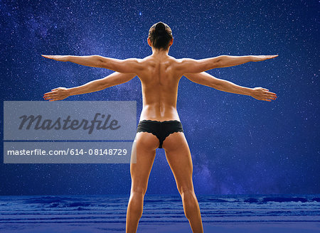 Rear view composite of young woman with four arms wearing knickers in front  of blue sky and seascape - Stock Photo - Masterfile - Premium Royalty-Free,  Code: 614-08148729