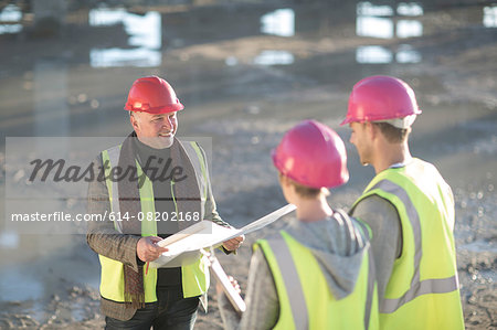 Architect meeting with builders on construction site