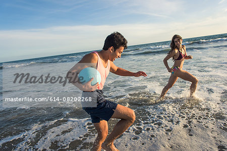Young couple fooling around in sea