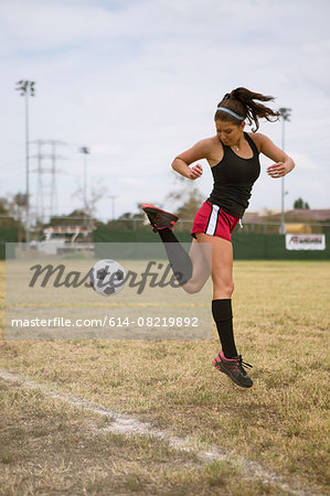 Soccer player practising in field