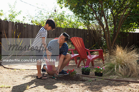 Father and son planting in garden