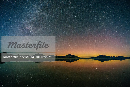 Reflecting pool of mountain range and Milky Way in dramatic night sky, Bonneville, Utah, USA