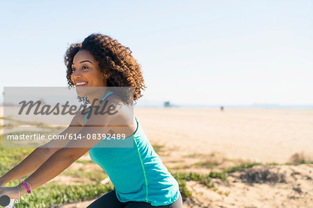 Mid adult woman cycling near beach