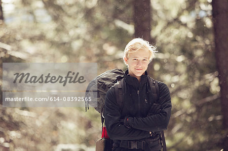 Portrait of young male hiker in sunlit forest, Ashland, Oregon, USA