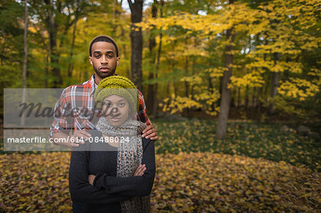 Portrait of mid adult couple standing in autumn forest