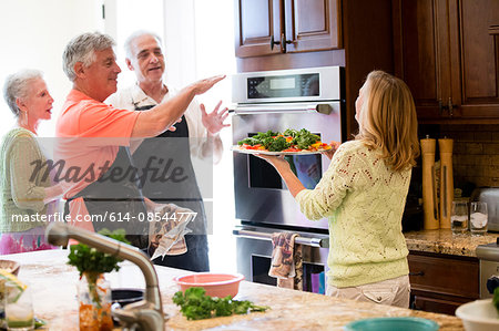 Group of seniors preparing meal in kitchen