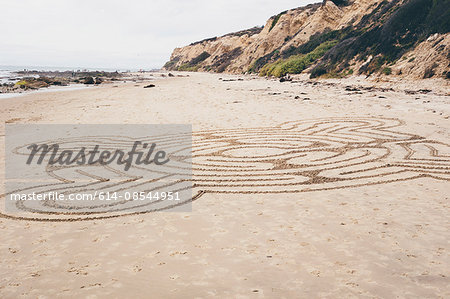 Line drawing pattern drawn onto beach sand, Crystal Cove State Park, Laguna Beach, California, USA
