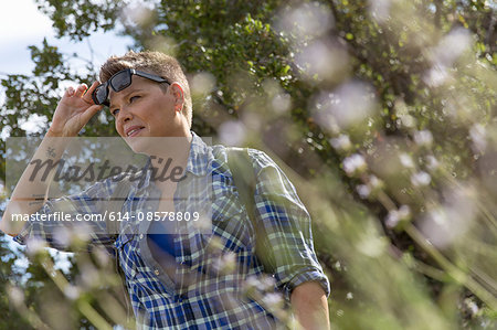 Woman hiker wearing sunglasses looking away