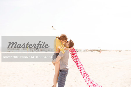 Couple on beach kissing, Coney island, Brooklyn, New York, USA