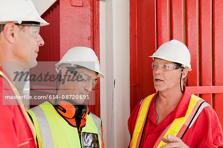 Engineers in brainstorming session on oil rig