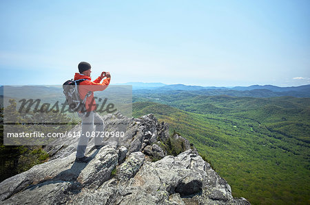 Male hiker taking smartphone photographs from ridge, Blue Ridge Mountains, North Carolina, USA