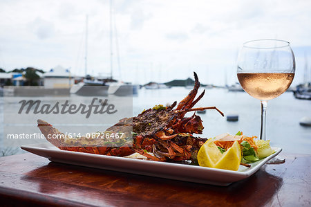 Light seafood dish, glass of rose wine
